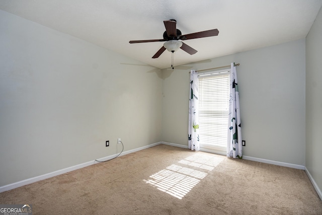 carpeted empty room featuring ceiling fan