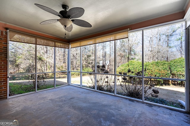 unfurnished sunroom with ceiling fan