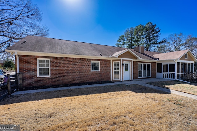 view of front of property with a patio area and a sunroom