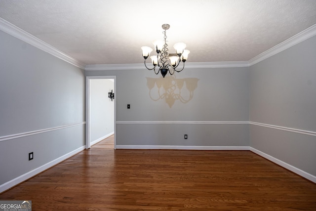 unfurnished room with a notable chandelier, crown molding, dark hardwood / wood-style floors, and a textured ceiling