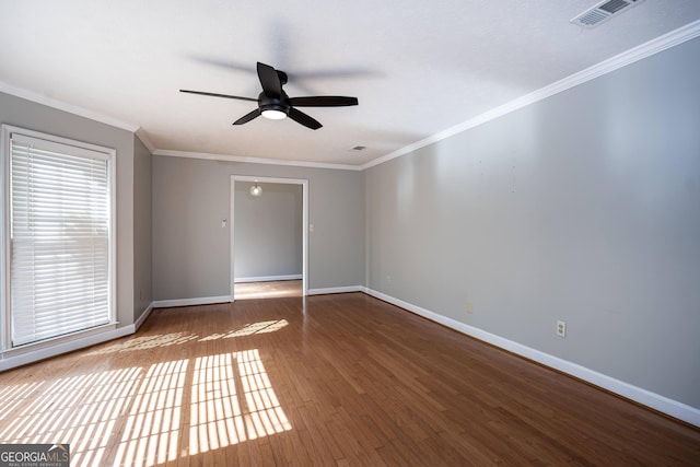 unfurnished room featuring hardwood / wood-style flooring, crown molding, and ceiling fan