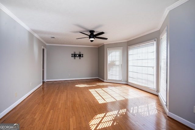 empty room with crown molding, ceiling fan, and light wood-type flooring