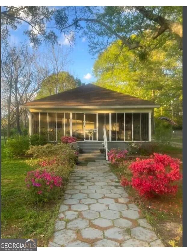 back of property featuring a sunroom