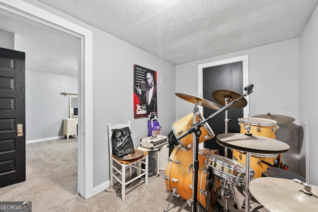 miscellaneous room with light colored carpet and a textured ceiling