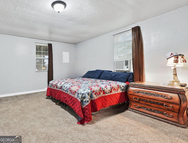 carpeted bedroom with multiple windows, cooling unit, and a textured ceiling