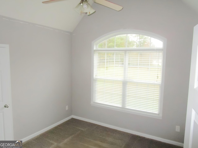 carpeted empty room featuring vaulted ceiling and ceiling fan