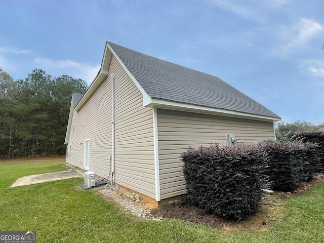 view of home's exterior with a lawn and central air condition unit