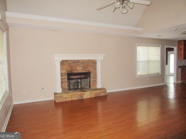 unfurnished living room with ceiling fan, lofted ceiling, a fireplace, and dark hardwood / wood-style flooring