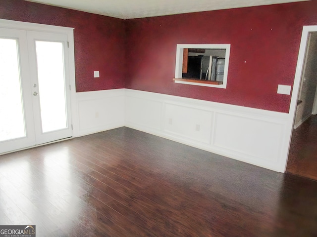 empty room with french doors and dark hardwood / wood-style floors