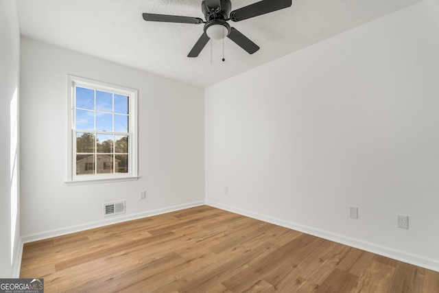 unfurnished room featuring ceiling fan, light hardwood / wood-style flooring, and a textured ceiling