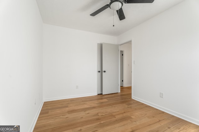 unfurnished room featuring ceiling fan and light wood-type flooring