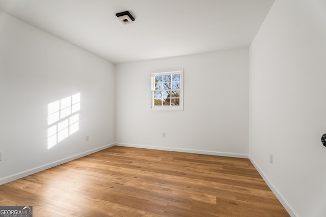 unfurnished room featuring wood-type flooring