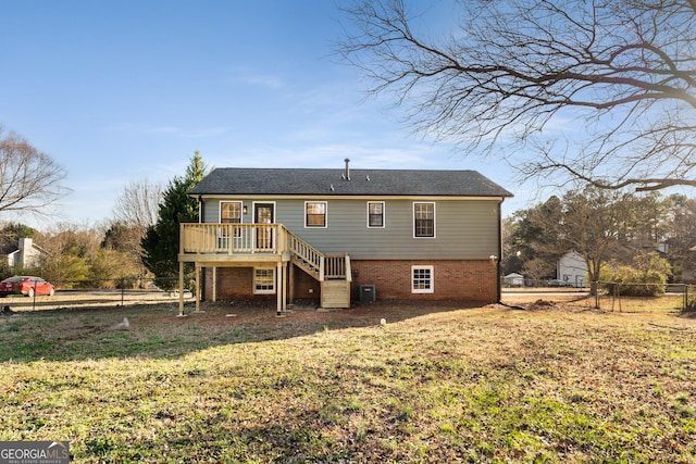 back of house featuring central AC unit, a yard, and a deck