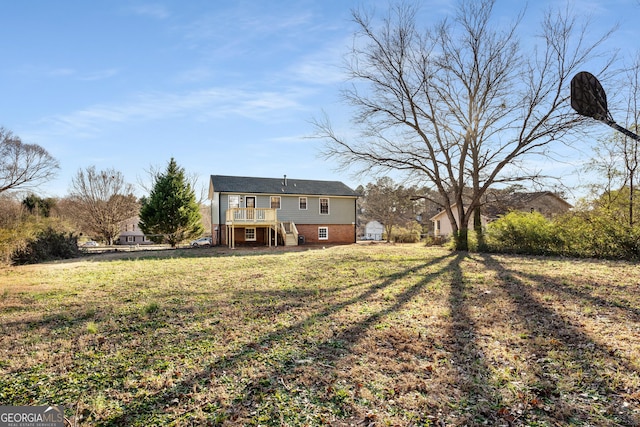 rear view of property with a yard