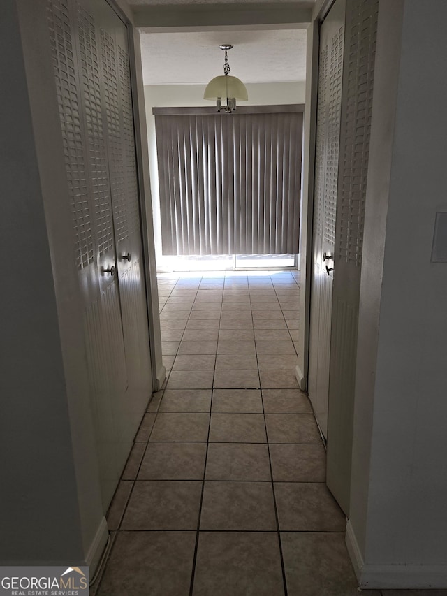 hall featuring light tile patterned flooring