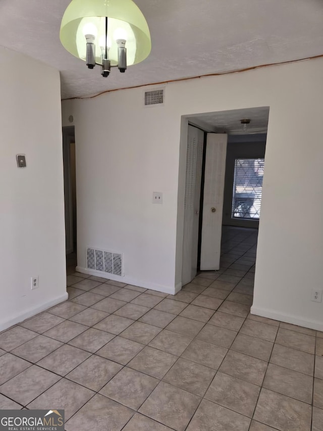 unfurnished room with light tile patterned floors