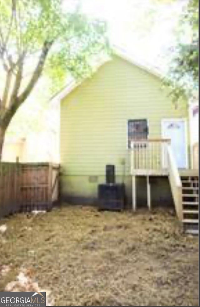 view of property exterior featuring central AC unit and a deck