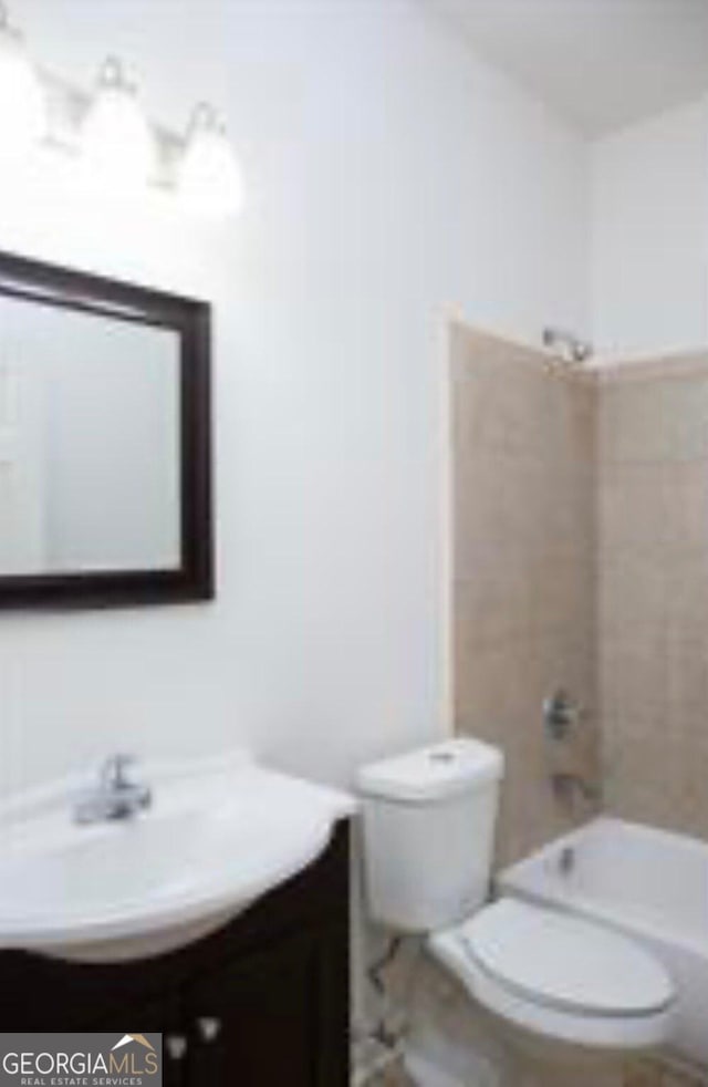 full bathroom with vanity, toilet, and tiled shower / bath combo