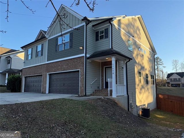 view of front of home with a garage and central AC unit