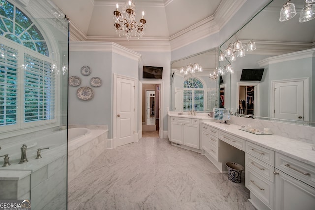 bathroom featuring crown molding, vanity, an inviting chandelier, and tiled tub