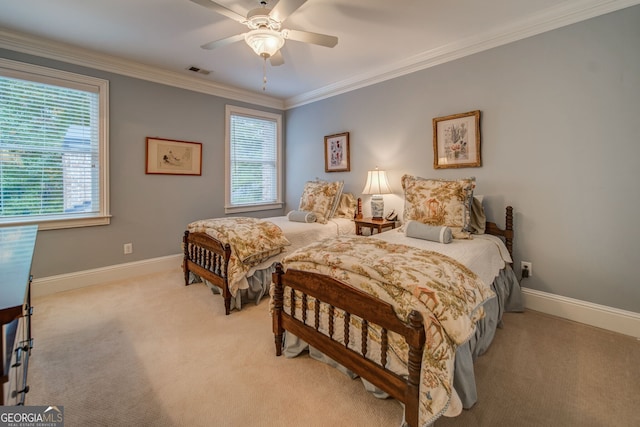 bedroom with multiple windows, crown molding, light colored carpet, and ceiling fan