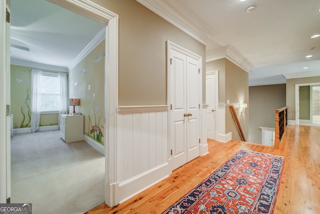 hallway featuring ornamental molding and light wood-type flooring