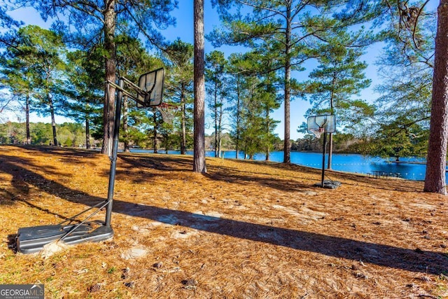 view of basketball court featuring a water view and community basketball court