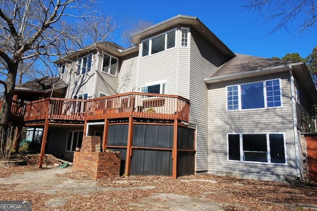 back of property featuring a wooden deck