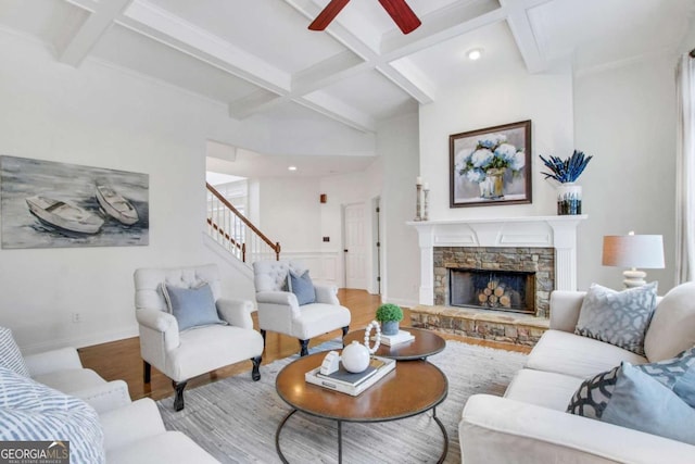 living room featuring coffered ceiling, a fireplace, hardwood / wood-style flooring, and beam ceiling