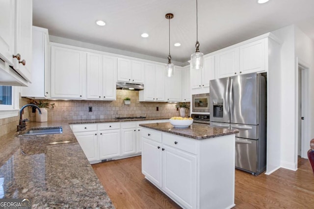 kitchen featuring white cabinetry, sink, a kitchen island, and appliances with stainless steel finishes