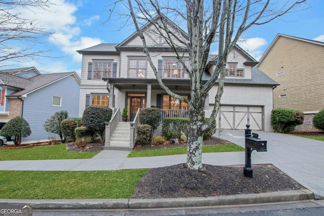 view of front facade with a porch, a garage, and a front lawn