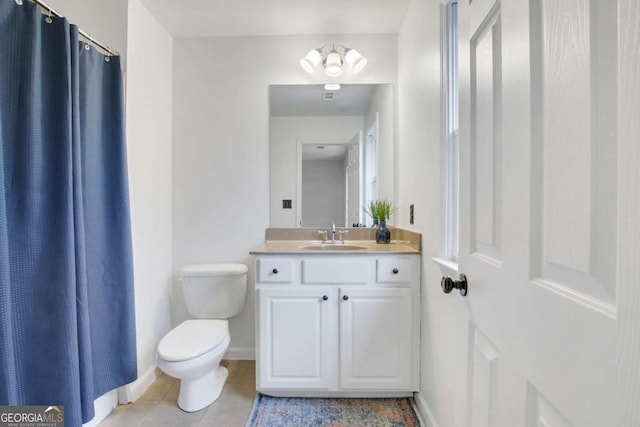 bathroom with vanity, tile patterned floors, and toilet