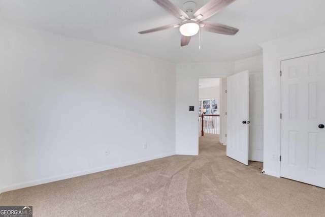 unfurnished bedroom with crown molding, light carpet, and ceiling fan