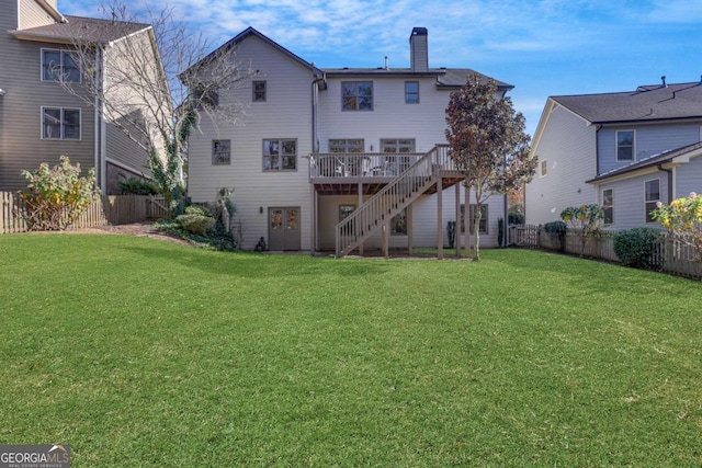 back of property featuring a lawn and a deck