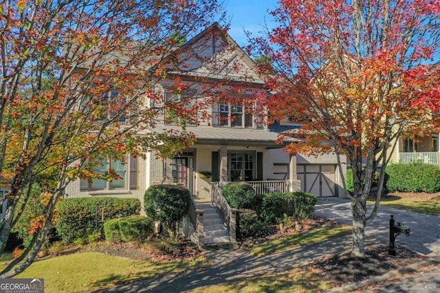 obstructed view of property featuring a garage and covered porch