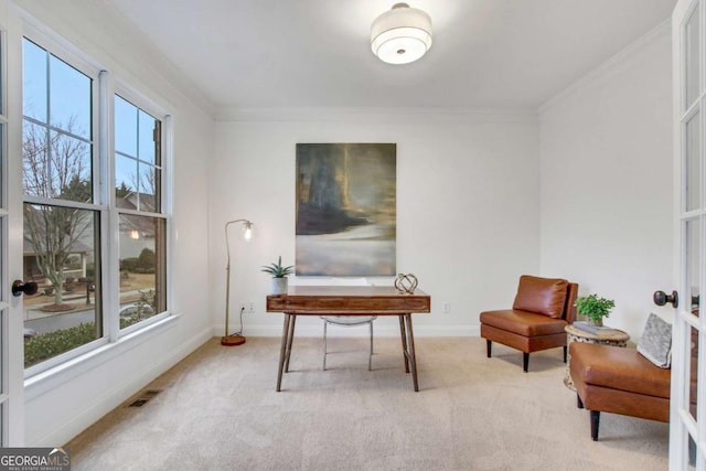 sitting room featuring crown molding, plenty of natural light, light colored carpet, and french doors