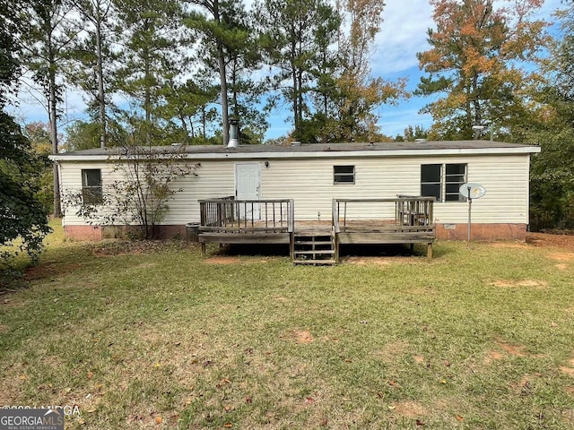 rear view of house with a yard and a deck