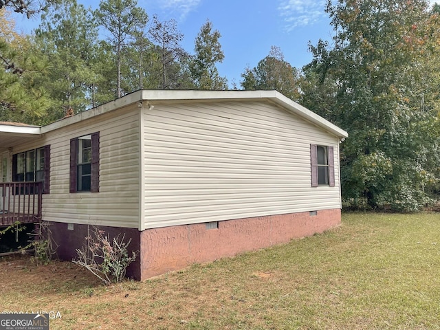 view of side of home featuring a lawn