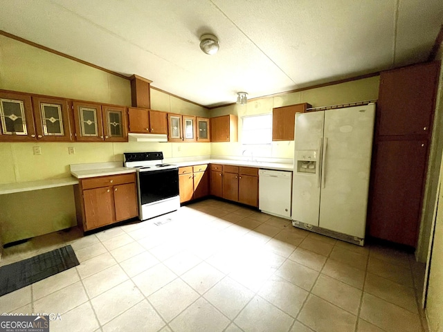 kitchen featuring vaulted ceiling, crown molding, and white appliances