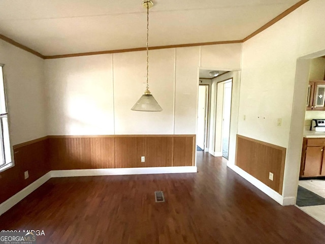 unfurnished dining area with ornamental molding and dark hardwood / wood-style flooring