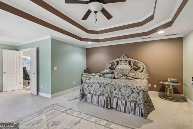 carpeted bedroom featuring ornamental molding, a raised ceiling, and ceiling fan