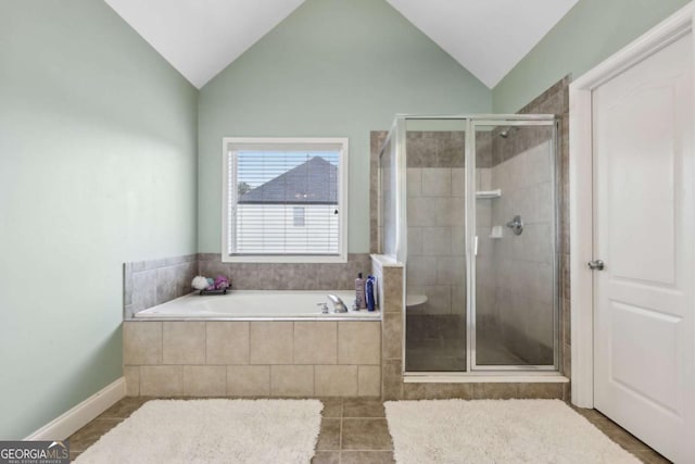 bathroom with vaulted ceiling, separate shower and tub, and tile patterned floors