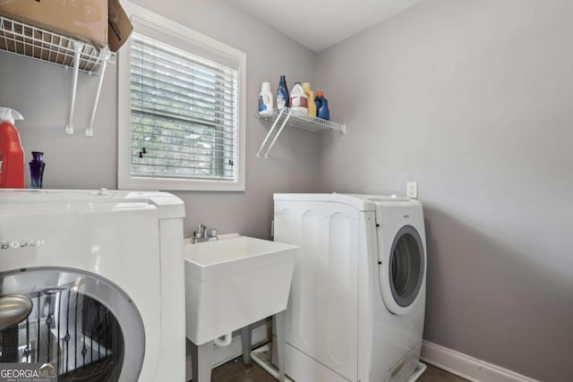 laundry room featuring sink and washer and clothes dryer