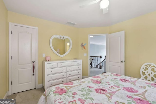 bedroom featuring light colored carpet and ceiling fan