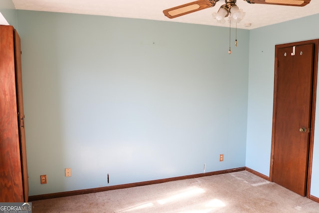 empty room featuring ceiling fan and light colored carpet