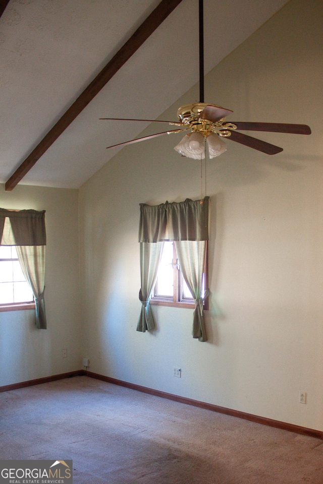 empty room featuring baseboards, vaulted ceiling with beams, carpet, and a ceiling fan