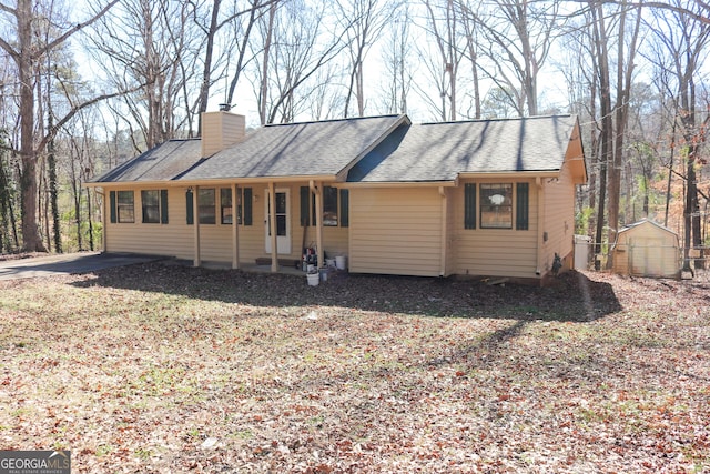 single story home featuring a storage shed