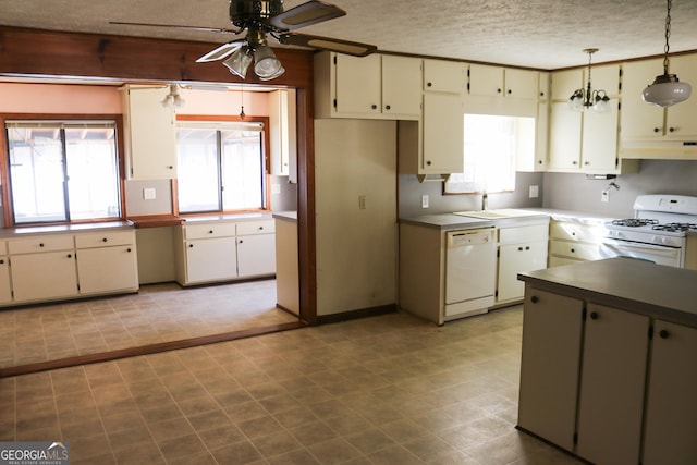 kitchen with sink, white appliances, hanging light fixtures, a textured ceiling, and ceiling fan