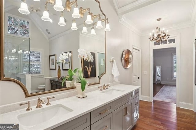 bathroom featuring lofted ceiling, ornamental molding, toilet, and hardwood / wood-style floors