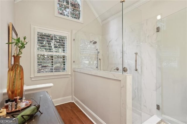 bathroom featuring walk in shower, a healthy amount of sunlight, lofted ceiling, and crown molding